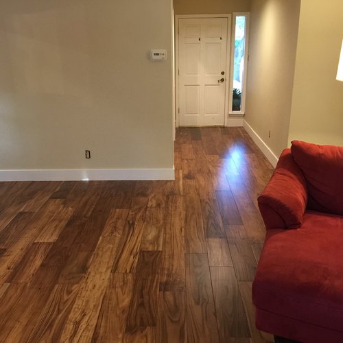 living room with hardwood floor Peoples Signature Flooring Austin Texas, 7.5 Inch Wide Hand Sculpted Acacia Natural 1x8 Baseboards